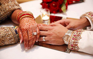 Asian wedding: husband and wife hands